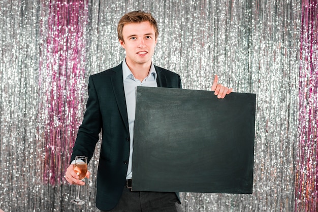 Man holding blackboard new year party