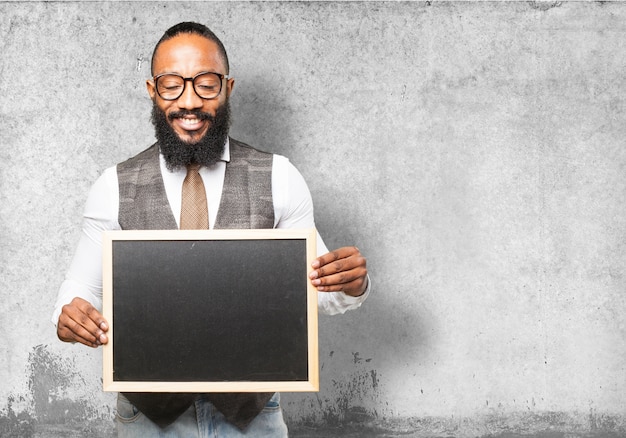 Free photo man holding a blackboard