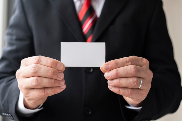 Man holding blank business card