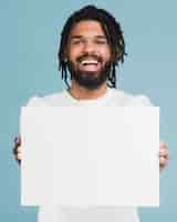 Free photo man holding a blank sign