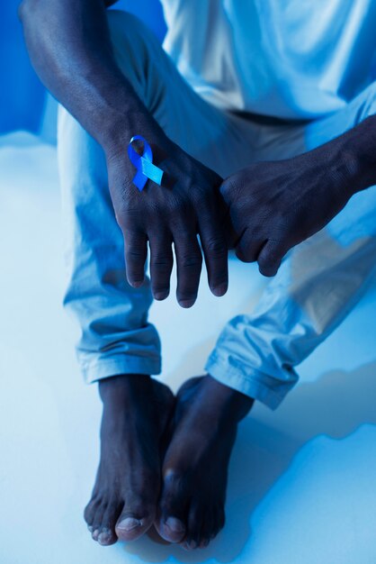 Man holding a blue ribbon