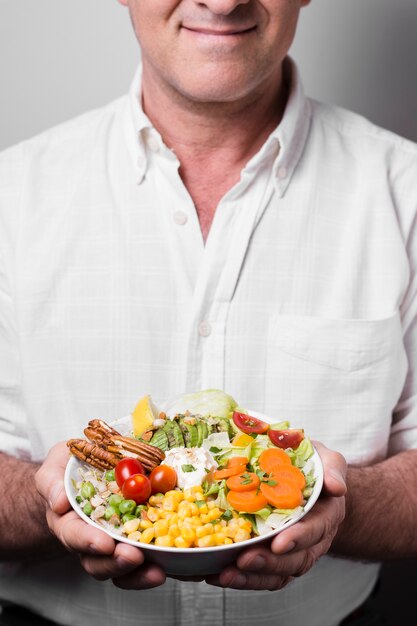 Man holding bowl of healthy food