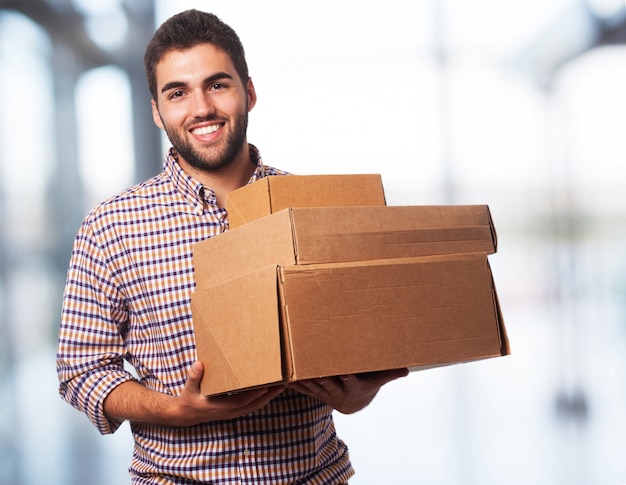 Free photo man holding boxes