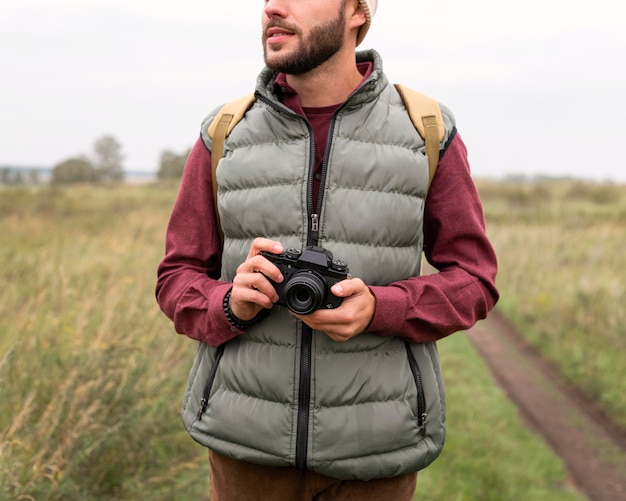 Man holding camera in nature