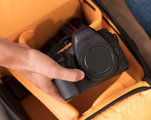 Man holding camera without lens