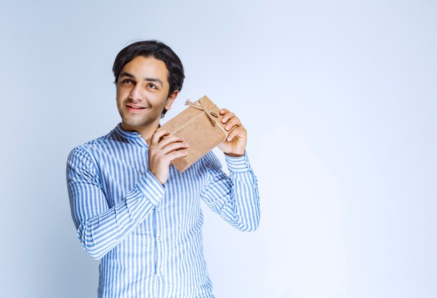 Man holding a cardboard gift box. High quality photo