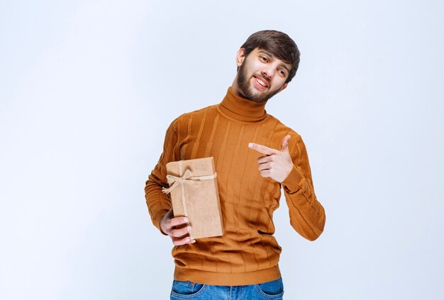 Man holding a cardboard gift box and presenting it
