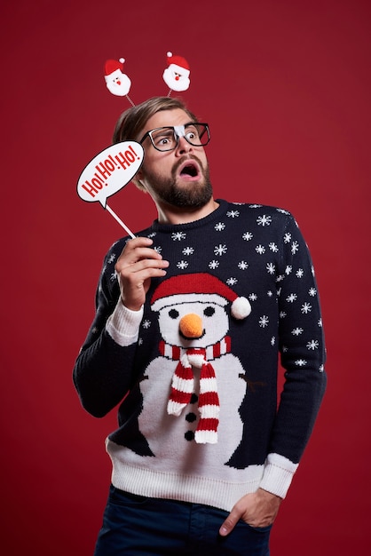 Free photo man holding a christmas mask isolated