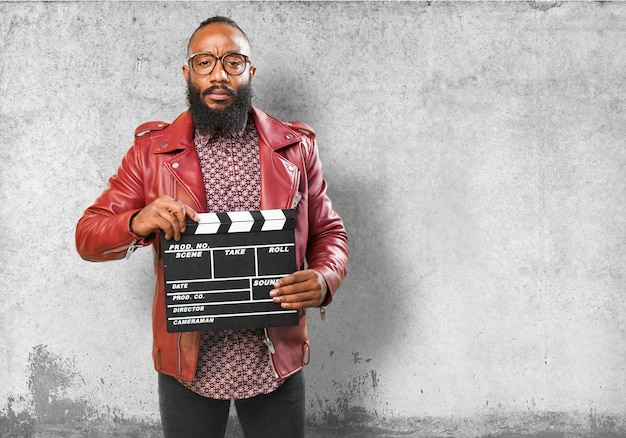 Free photo man holding a clapperboard