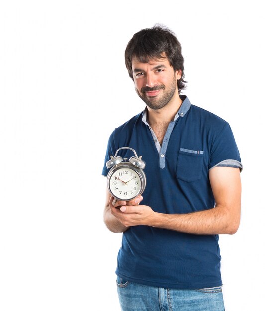 Man holding a clock over white background