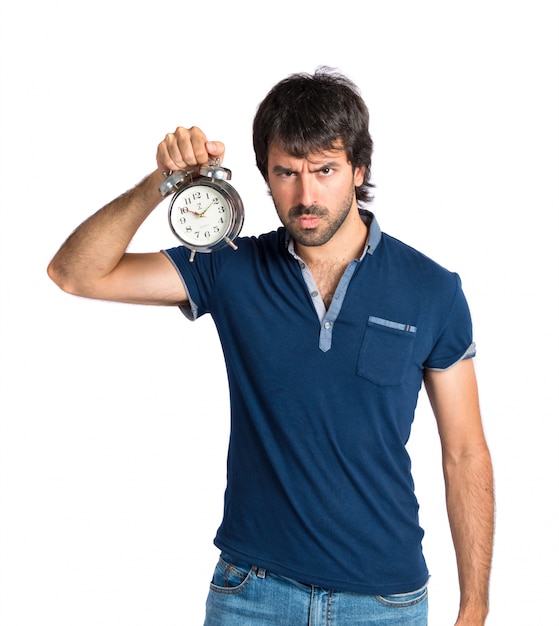 Man holding a clock over white background