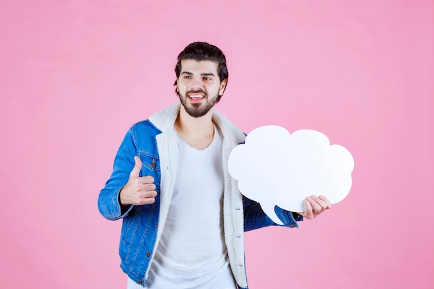 Man holding a cloud shape blank thinkboard and feeling like a winner