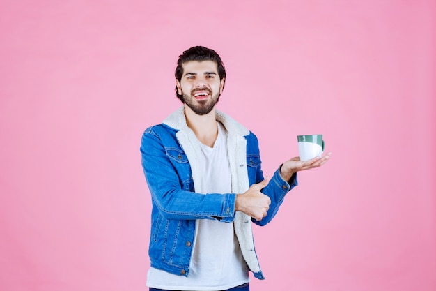 Man holding a coffee cup and enjoyed the taste