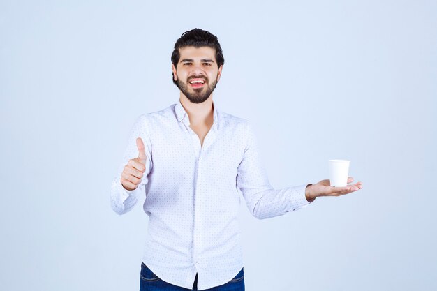 Man holding a coffee cup and enjoyed the taste