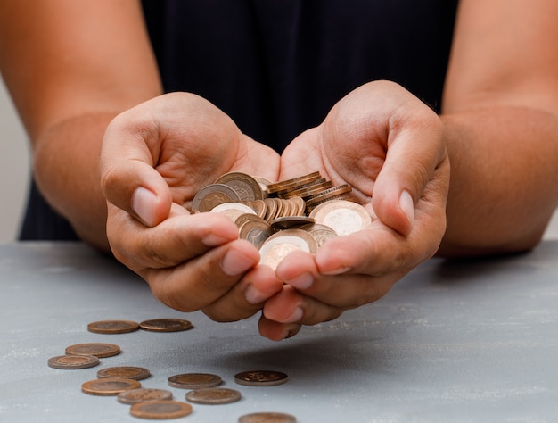 man holding coins in palm.