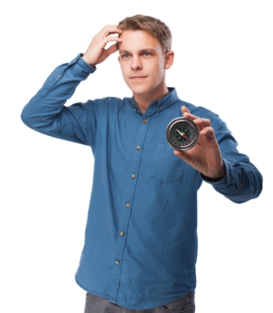 Free photo man holding a compass with one hand