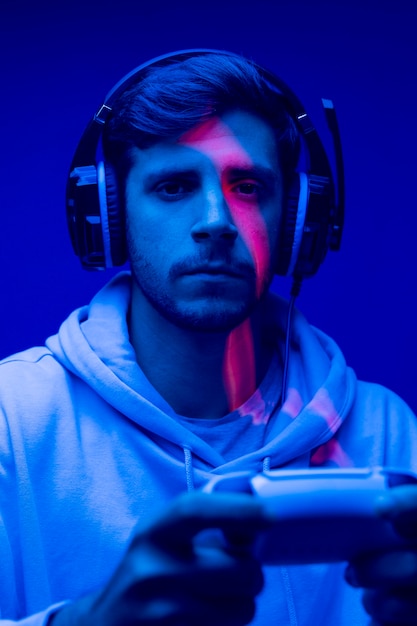 Free photo man holding  controller close up