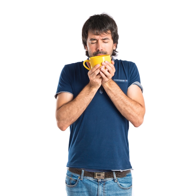 Man holding a cup of coffee over white background