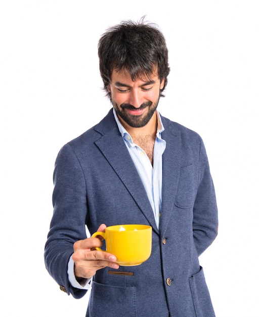 Man holding a cup of coffee over white background