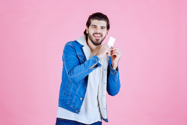 Man holding and demonstrating his business card to the new partners