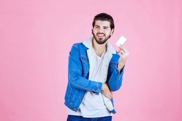 Man holding and demonstrating his business card to the new partners