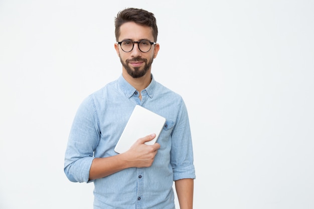 Man holding digital tablet and smiling at camera