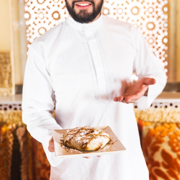 Man holding dish of arab food