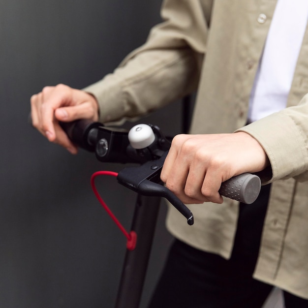 Man holding the electric scooter's handles