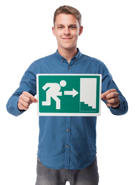 Man holding an emergency exit sign