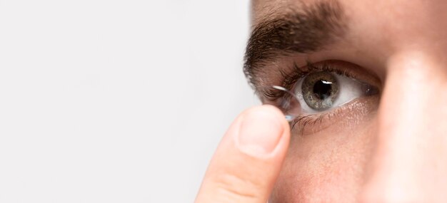 Man holding an eye contact with copy space