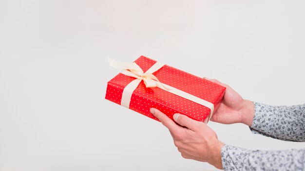 Man holding gift box in wrap