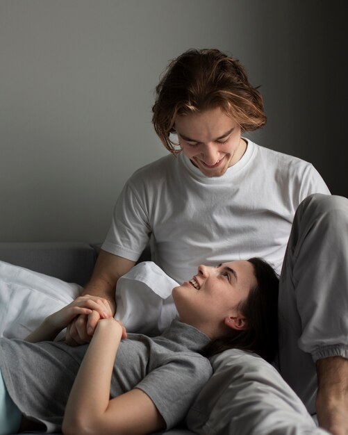 Man holding girlfriend's head on lap and smiling