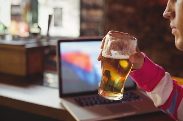 man holding a glass of beer