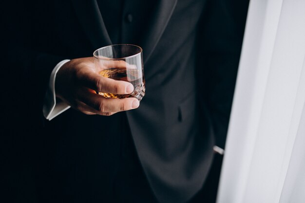 Man holding a glass of whiskey