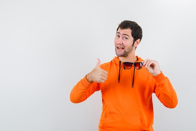 The man holding glasses is showing perfect gesture  on white background