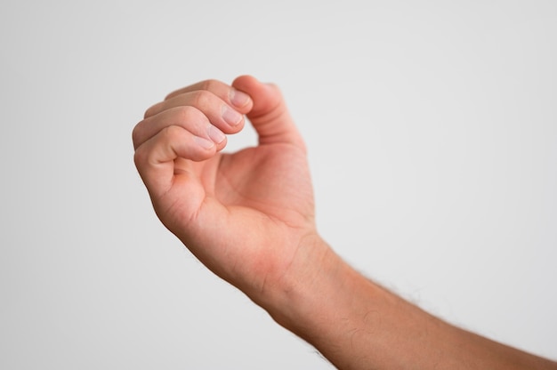 Man holding hand out and looking at fingernails