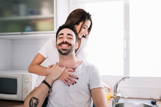 Man holding hand of woman in kitchen