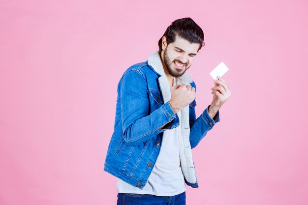 Man holding his business card and feeling like a winner