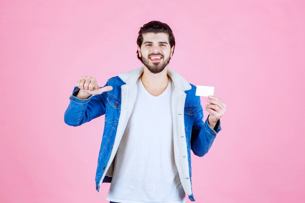 Man holding his business card and meaning his success