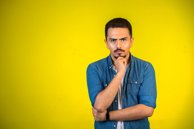 Man holding his chest and planning further steps,  front view