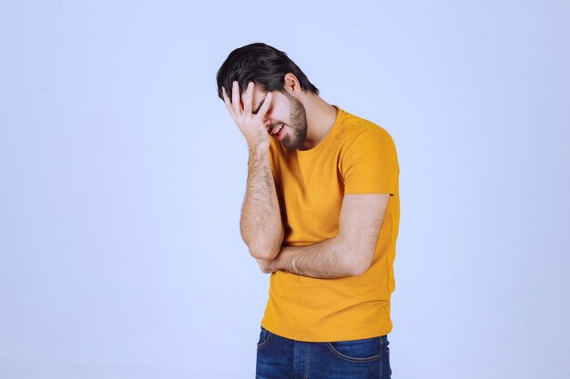 Man holding his head as he has headache.