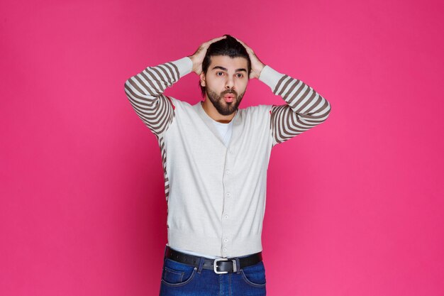 Man holding his head as he is exhausted or has headache. 