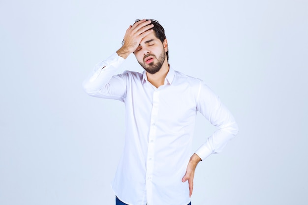 Man holding his head because of headache or feeling exhausted