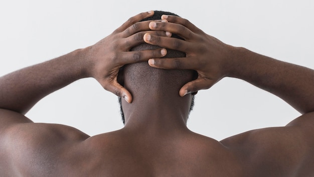 Man holding his head from behind shot