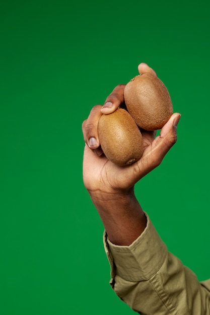 Man holding kiwi fruit