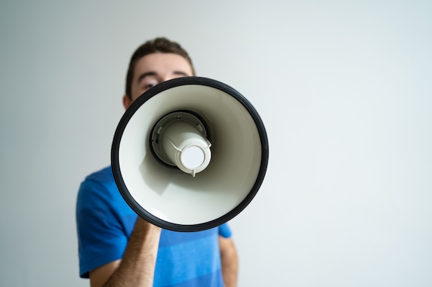 Man holding megaphone in front of his face