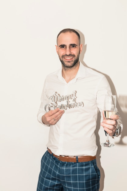 Man holding Merry Christmas inscription 