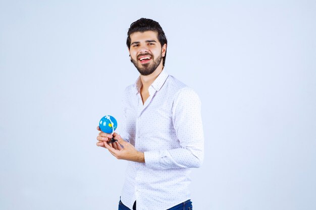 Man holding a mini world globe