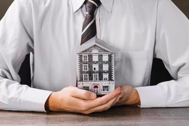 Man holding miniature house in hands