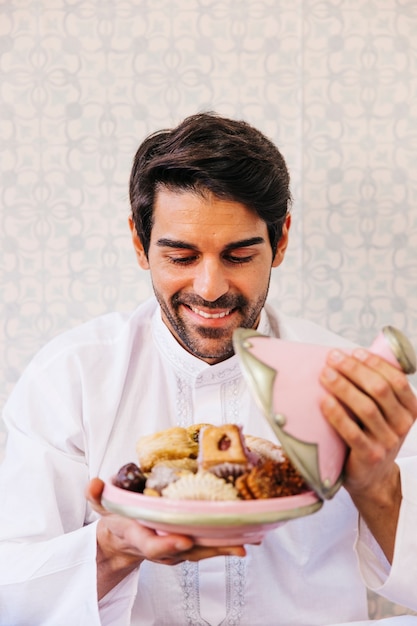 Man holding plate of delicious arab food